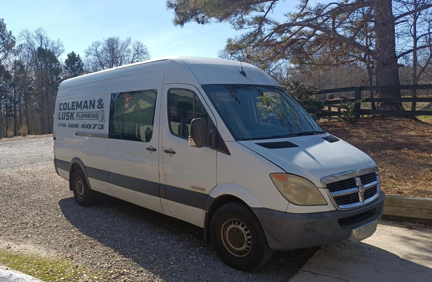 Coleman & Lusk Plumbing van overlooking a scenic landscape